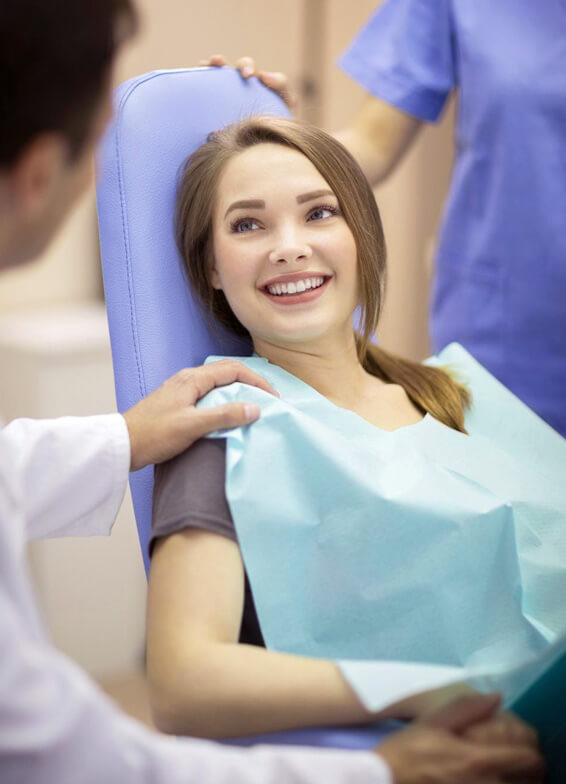 Young woman receiving dental care from dentist in professional clinic setting.
