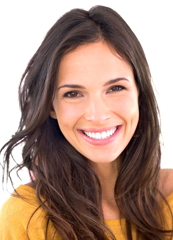 Smiling woman with dark hair wearing yellow shirt in professional headshot portrait
