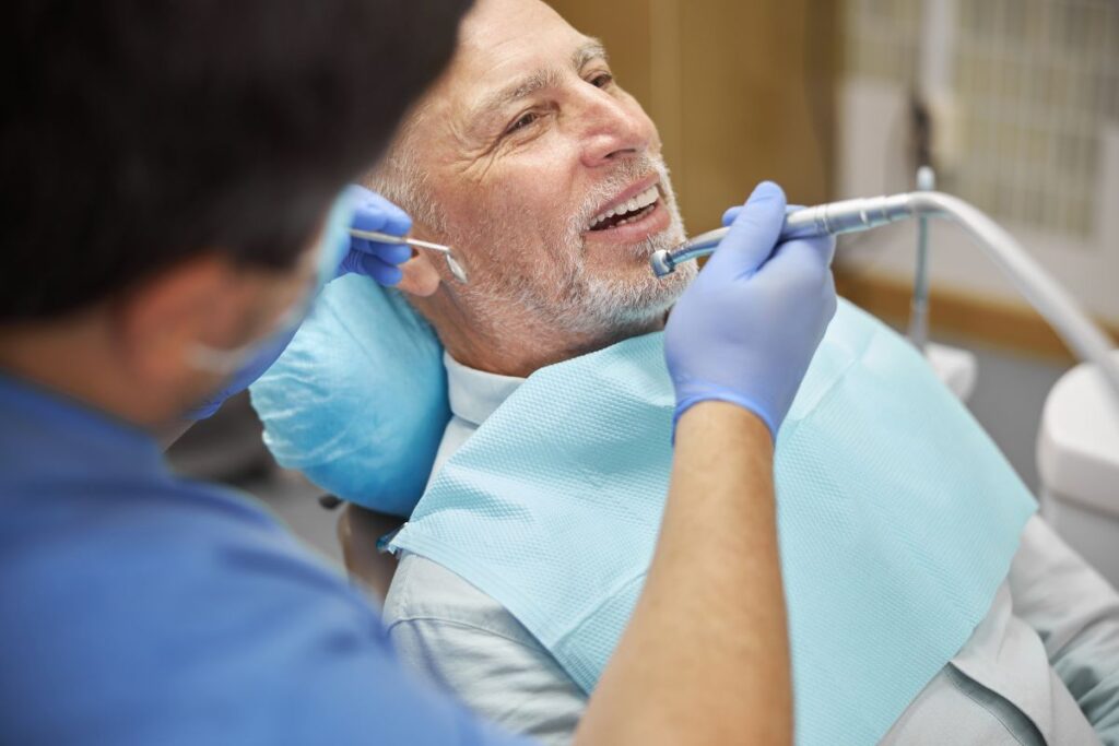 Patient discussing Dental Implants and Gum Disease with a dentist during a consultation to determine eligibility for implant treatment.